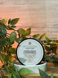 Pomata Zampe e Polpastrelli – Bava di Lumaca, Aloe & Burro di Cacao – 100 ml in a natural setting with leaves.